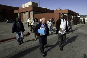Construction Manager Herman Blackmon, Jr., right, leads members of the Citizens Bond Oversight Committee on a tour of renovations at John F. Kennedy High
